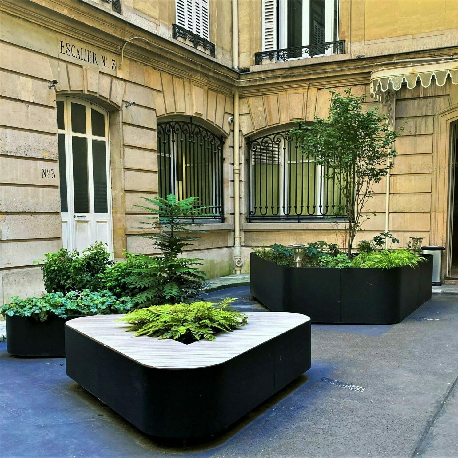 Bespoke triangular planter in painted aluminium and wood seats
